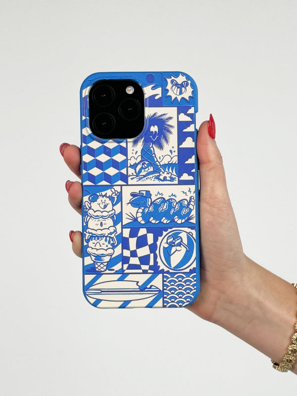 A hand with red nail polish holds the Pela Summer Blues Phone Case from the Pela x Cam Miller Artist Collaboration Collection. The case features a blue and white design with various summer-themed illustrations, including a palm tree, a coiled snake, and geometric patterns.